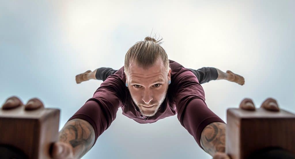 Bottom View of Coach Kyle Weiger doing half straddle handstand on a H-shape Canes Trainer