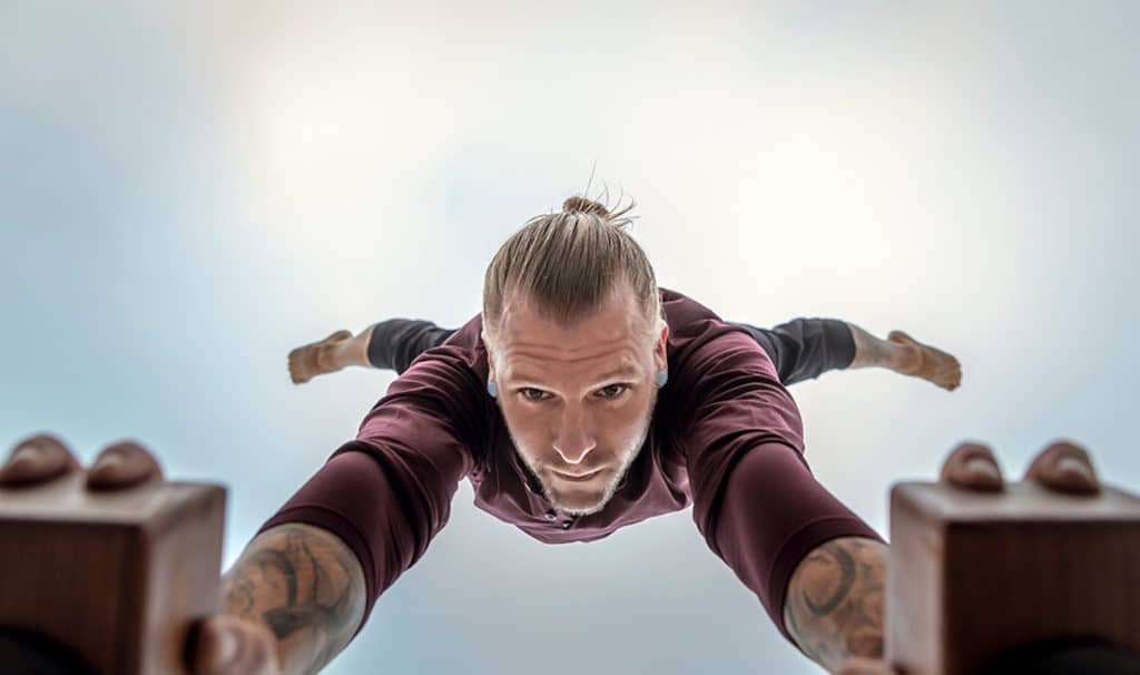 Bottom View of Coach Kyle Weiger doing half straddle handstand on a H-shape Canes Trainer