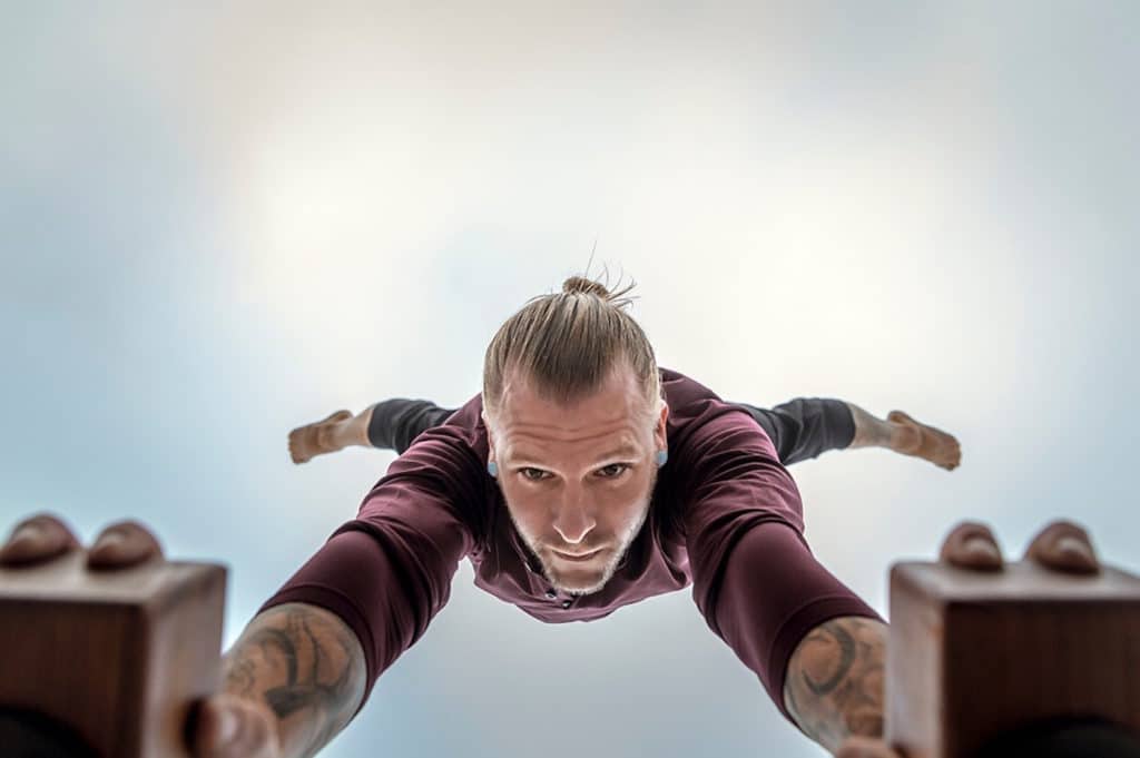 Bottom View of Coach Kyle Weiger doing half straddle handstand on a H-shape Canes Trainer