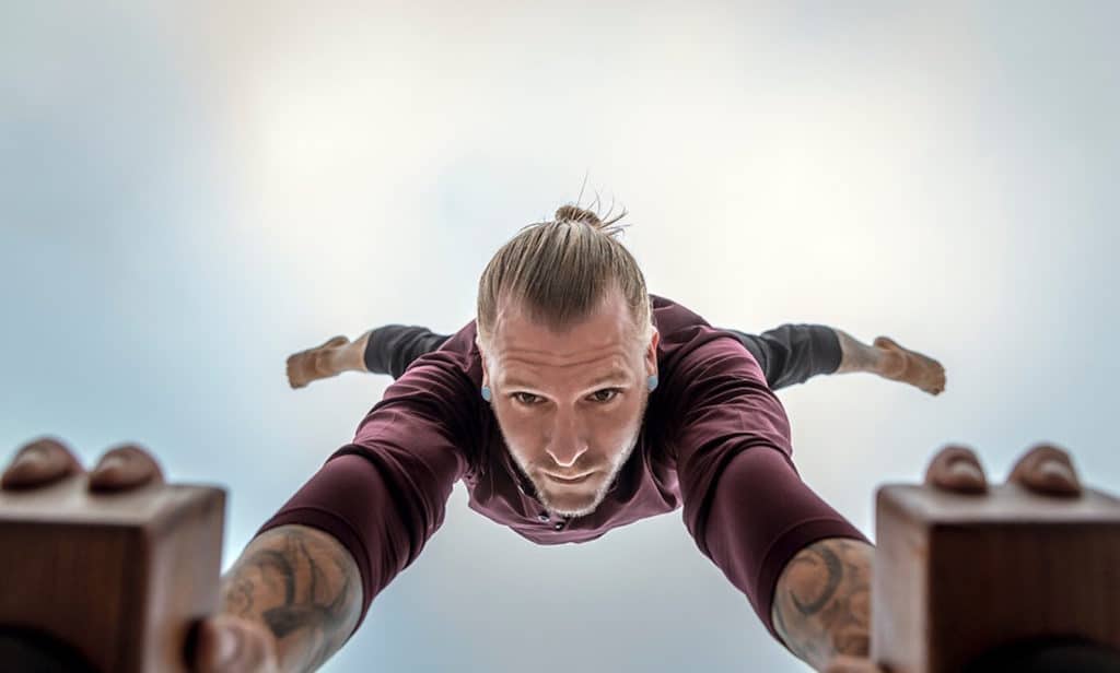 Bottom View of Coach Kyle Weiger doing half straddle handstand on a H-shape Canes Trainer