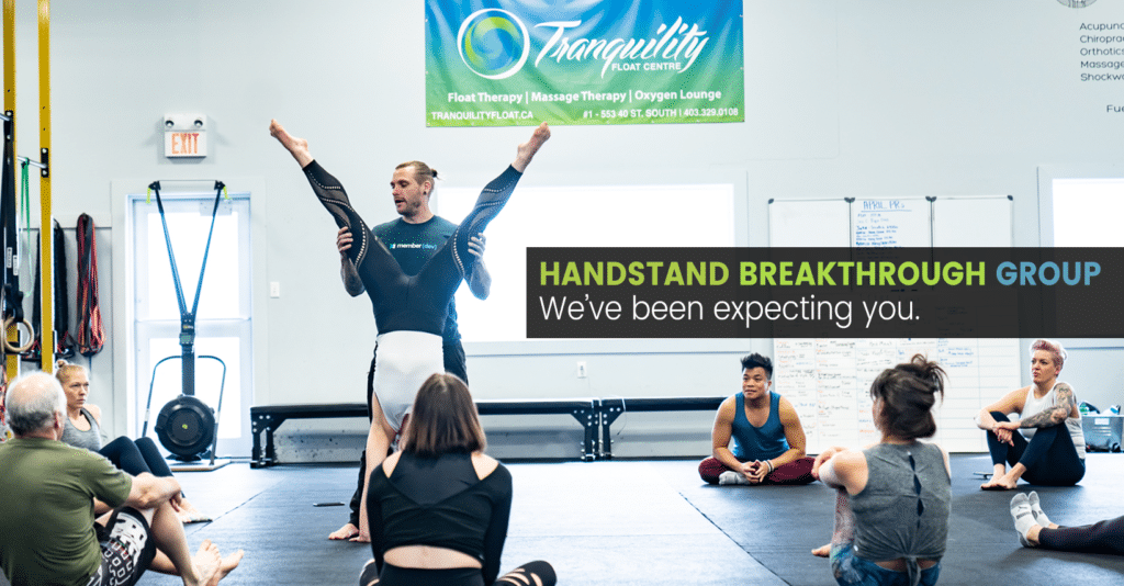 Instructor Kyle Weiger assists student in the gym while other members of the breakthrough group are watching