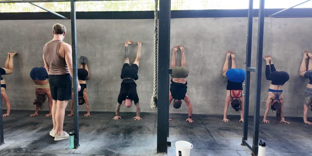 Wall Handstands in group class at handstand workshop.