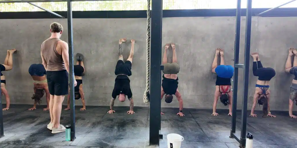 Wall Handstands in group class at handstand workshop.