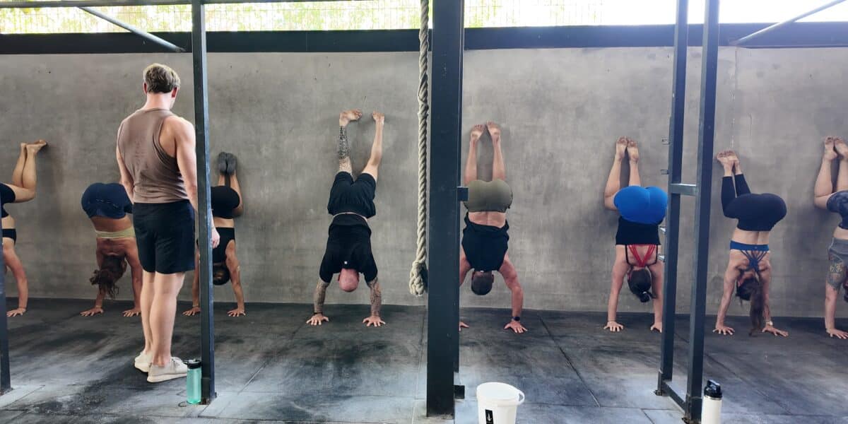 Wall Handstands in group class at handstand workshop.